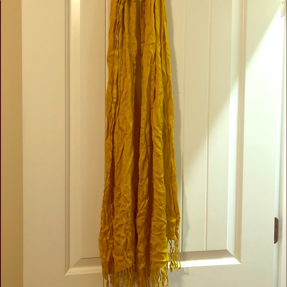 Gold scarf with fringe ends.